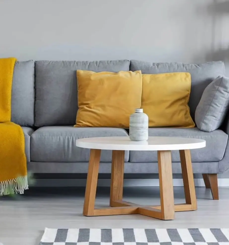 neutral color living room with grey sofa and yellow cushion