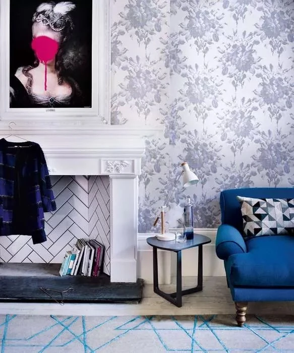 floral wallpaper and blue sofa with fireplace living room