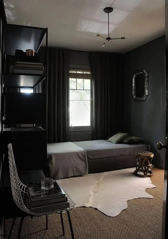 cozy bedroom in black with textual textiles