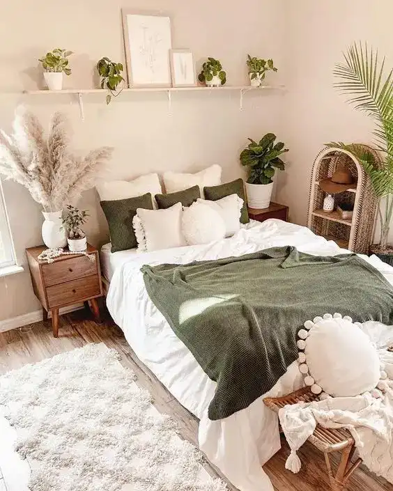 boho bedroom with off white walls and green bedding