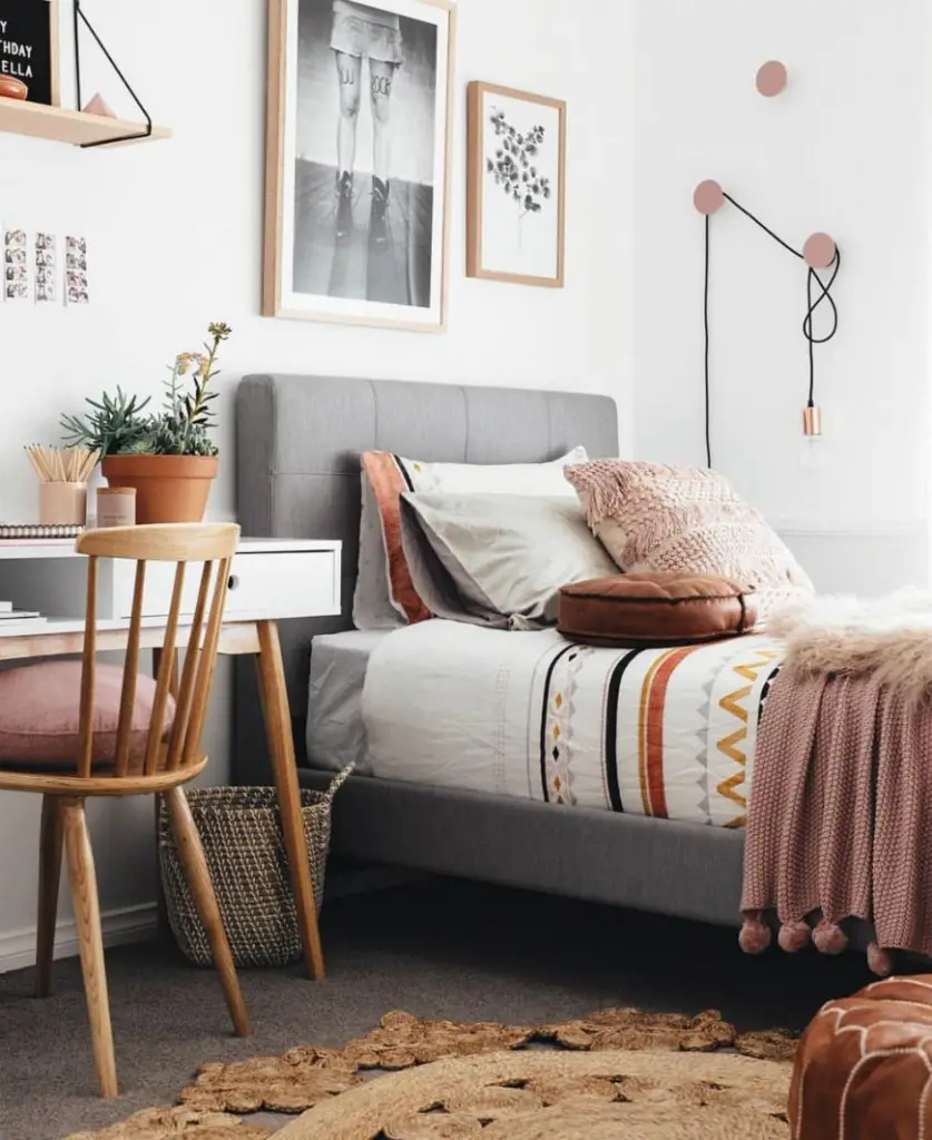 modern boho bedroom with different layer of bedding in warm colors