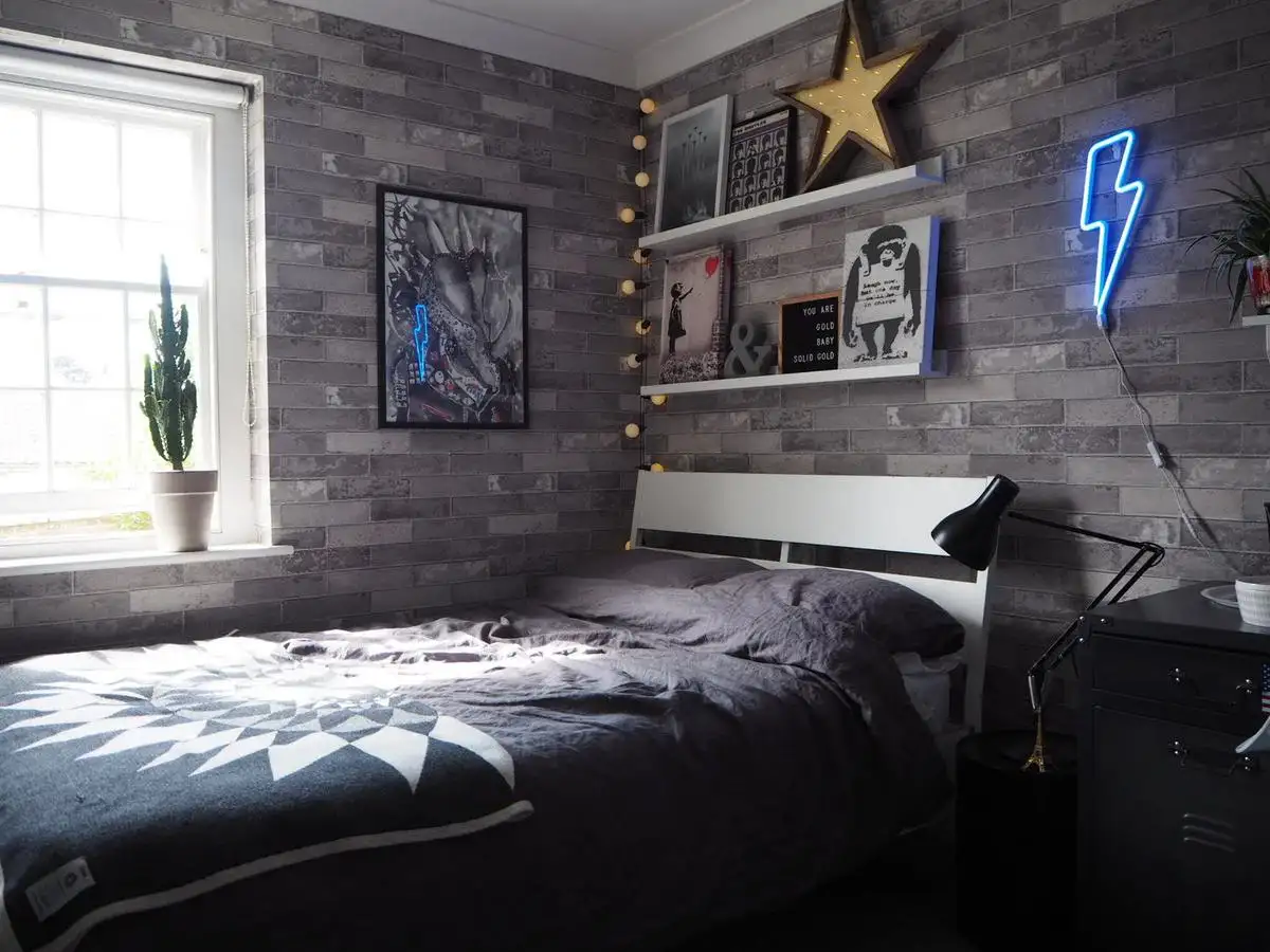 teen boy bedroom with neon light sign and gaming station