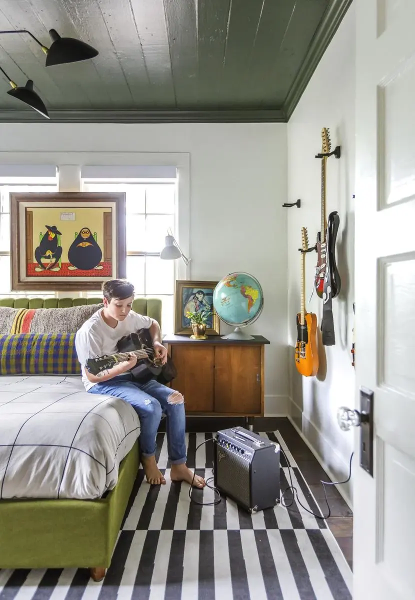 white and green teen boy bedroom with a teen playing guitar