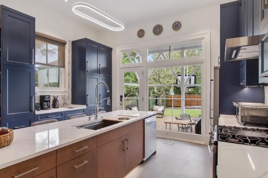 kitchen with navy blue cabinet and large windows