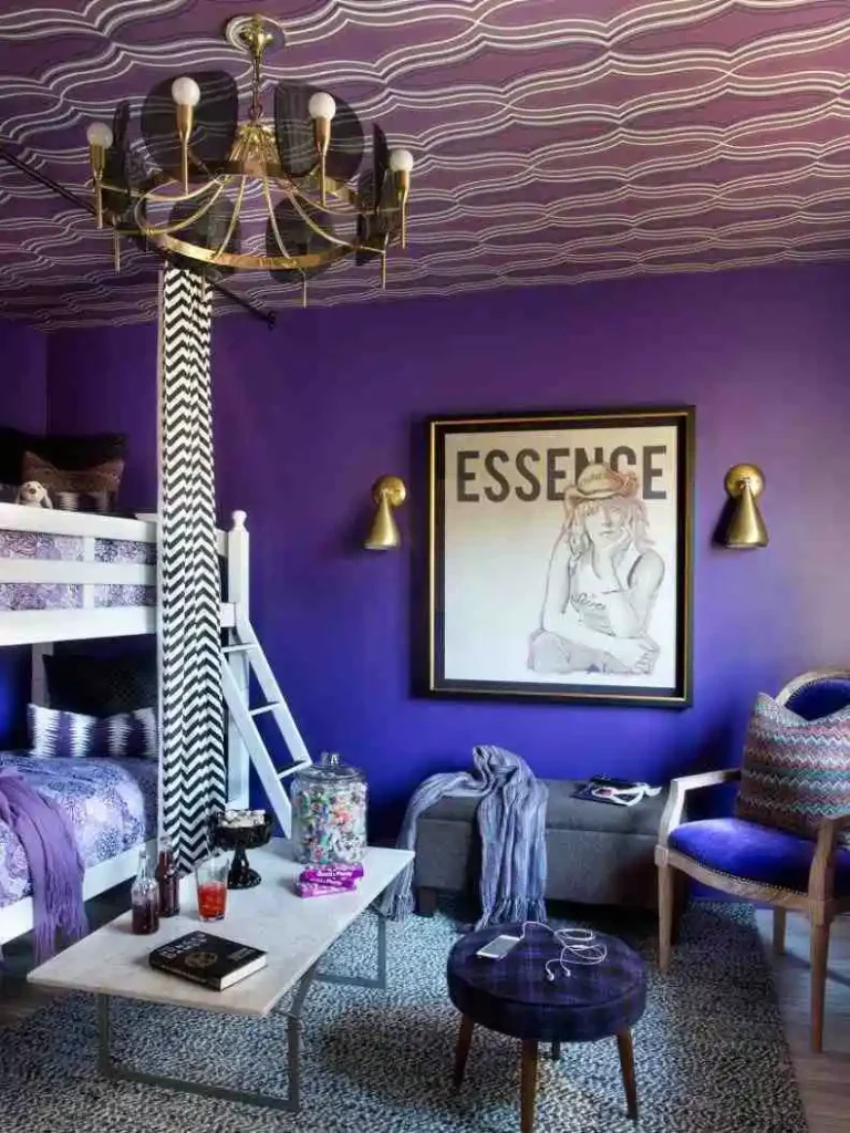 A bedroom with a mix of patterns, textures, and colors, featuring a vintage rug, a velvet armchair, and artwork. Teen Girl Bedroom