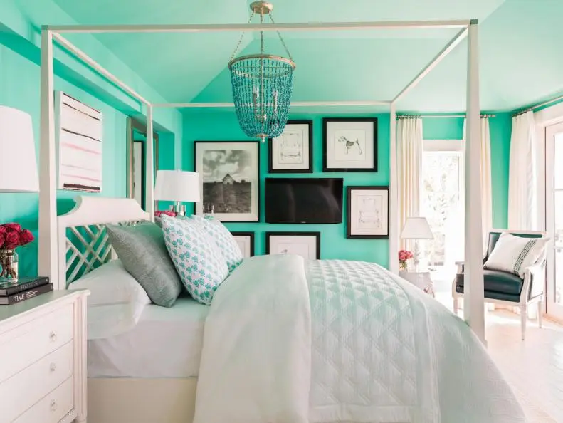 A bedroom with a teal accent wall, a gallery wall featuring a TV, and comfortable seating. Teen Girl Bedroom