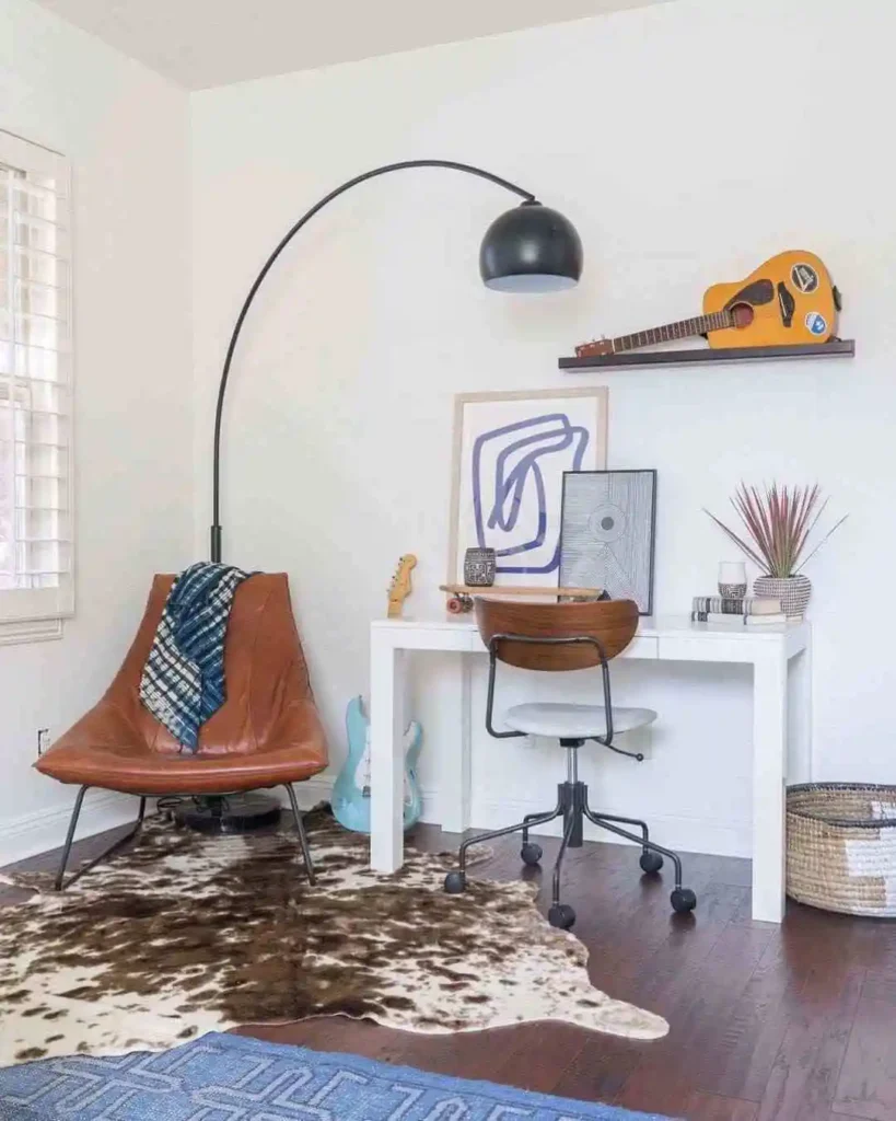 desk with a floor lamp and decorative items in teen girl bedroom