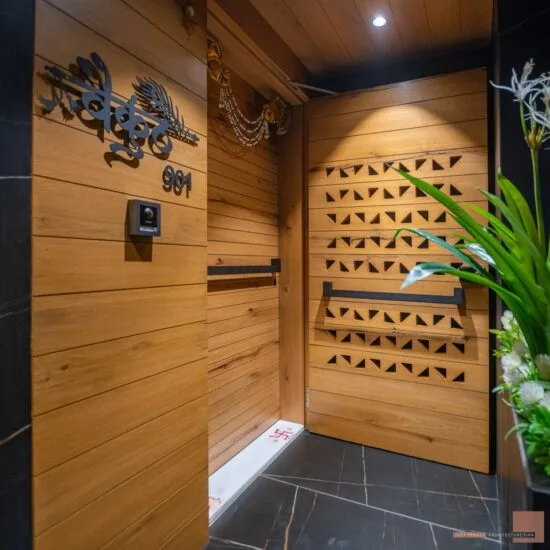 Majestic wooden door at flat entrance lobby design